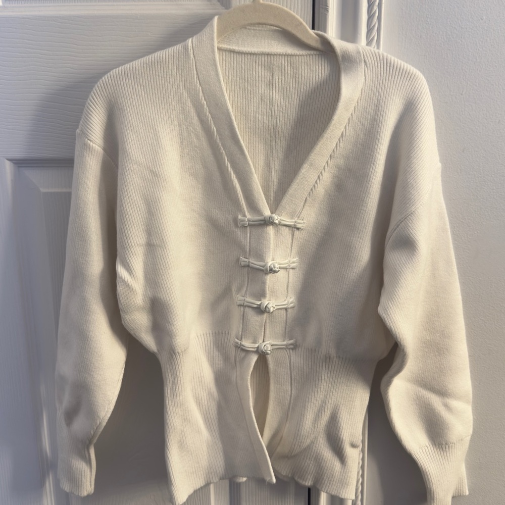 White sweater with bows